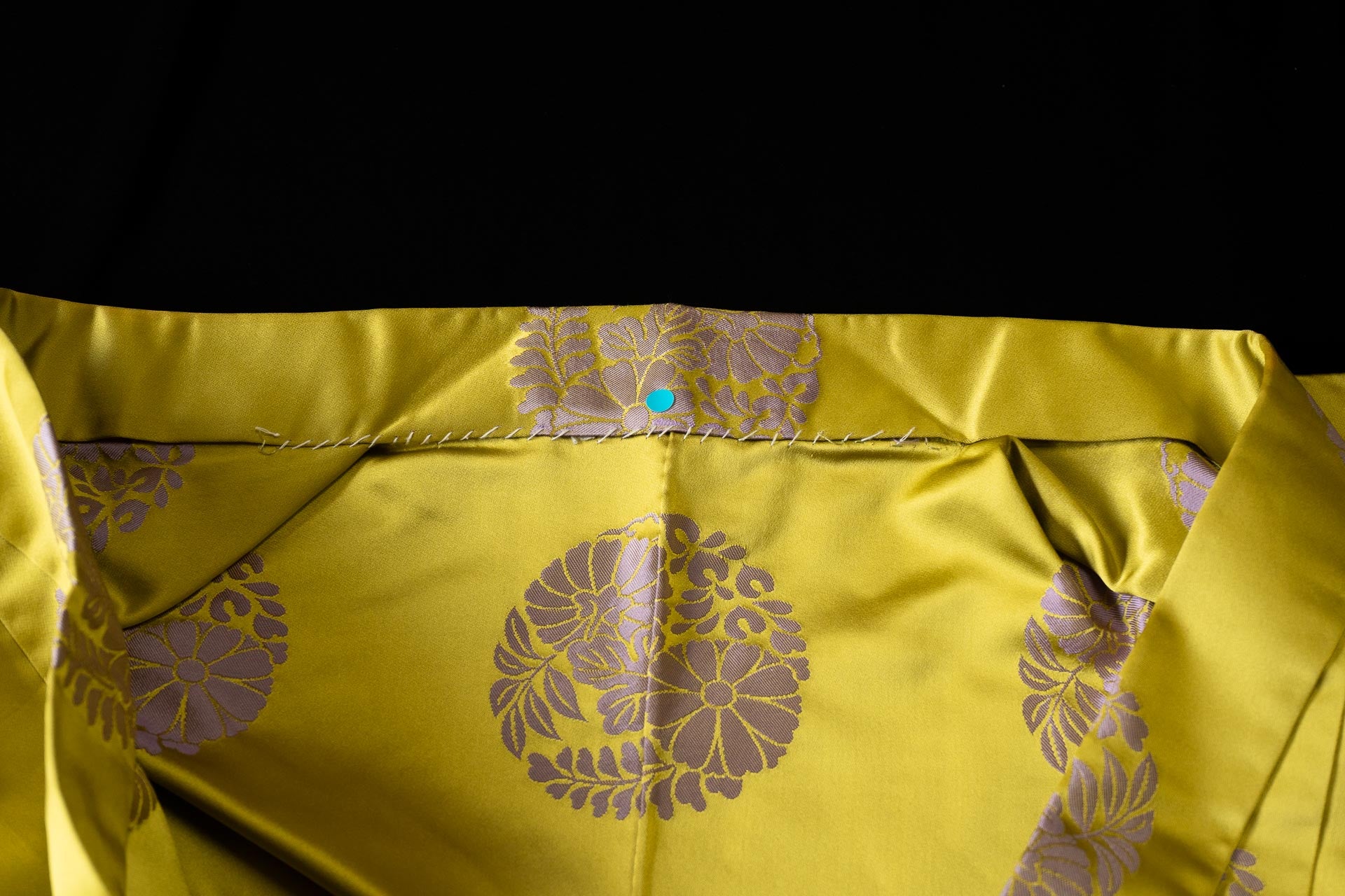 The collar area of a coloured robe